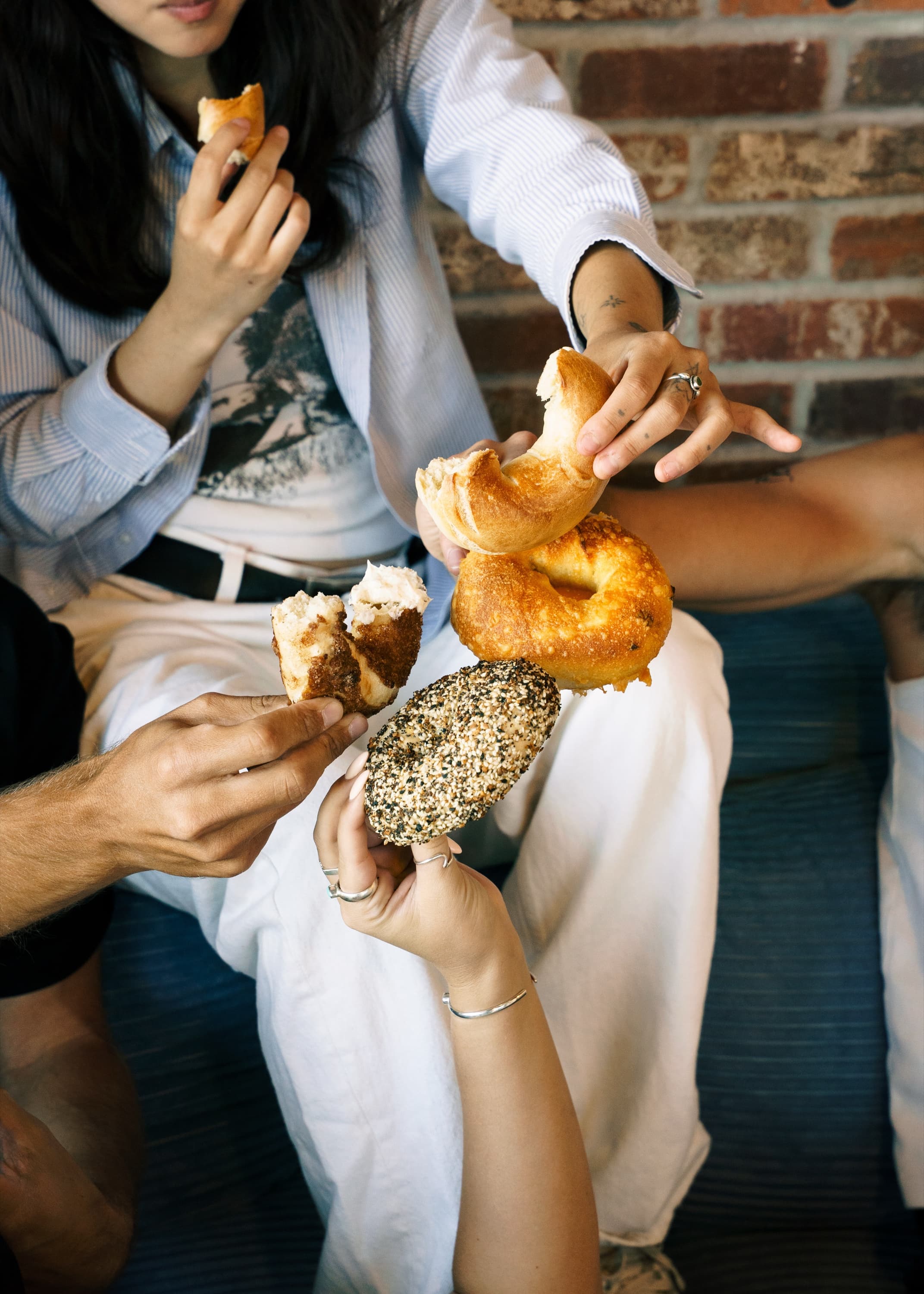 Friends sharing fresh bagels