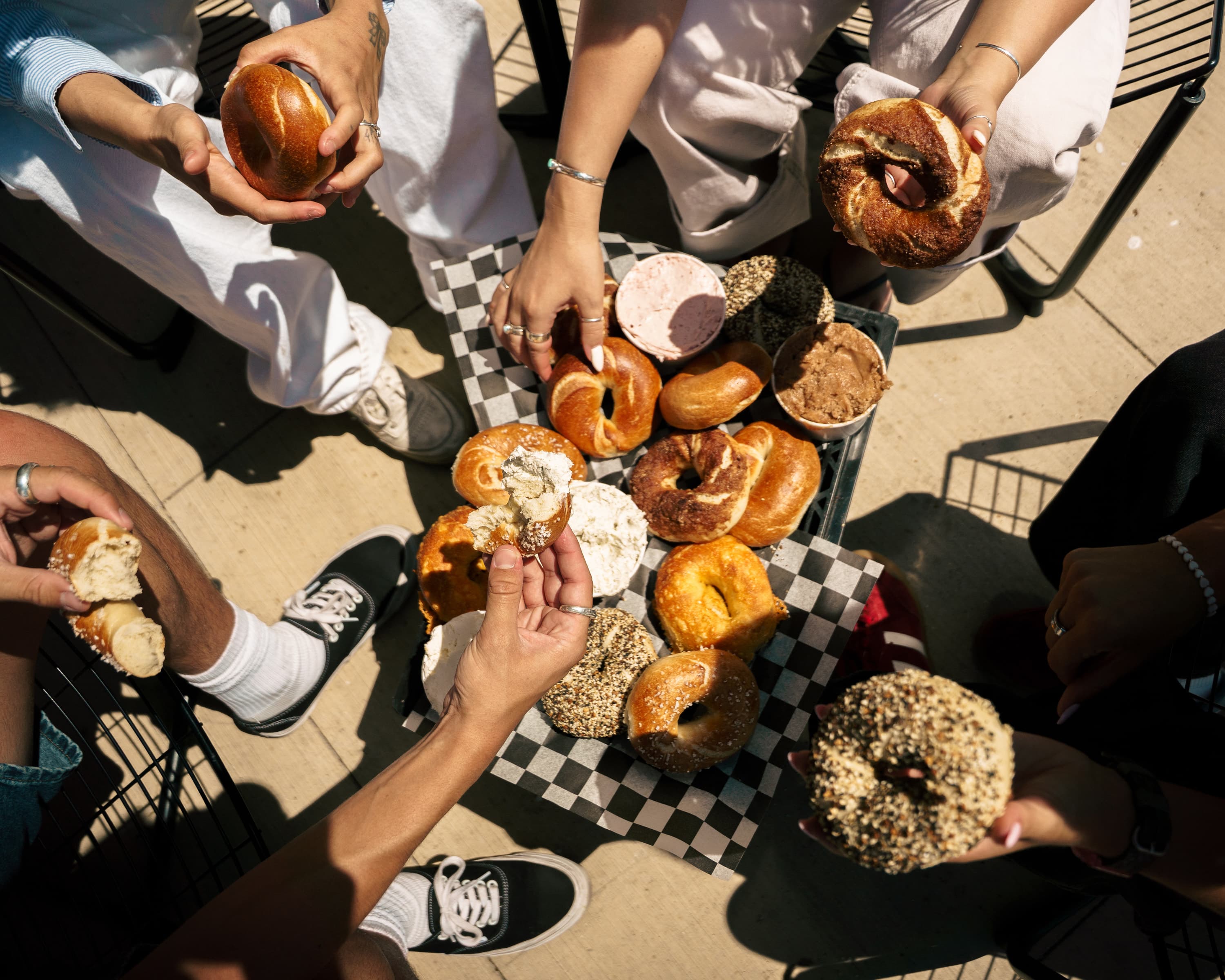 A group sharing a spread of bagels and schmears